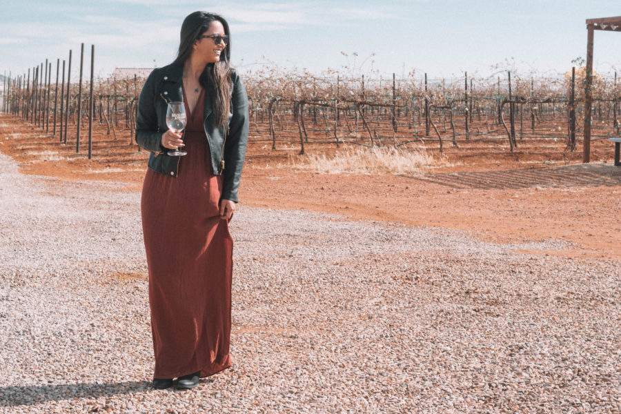 The perfect wine tasting outfit features a long dress and a moto jacket for some added edge!