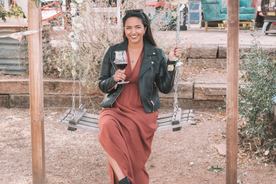 The perfect wine tasting outfit features a long dress and a moto jacket for some added edge!
