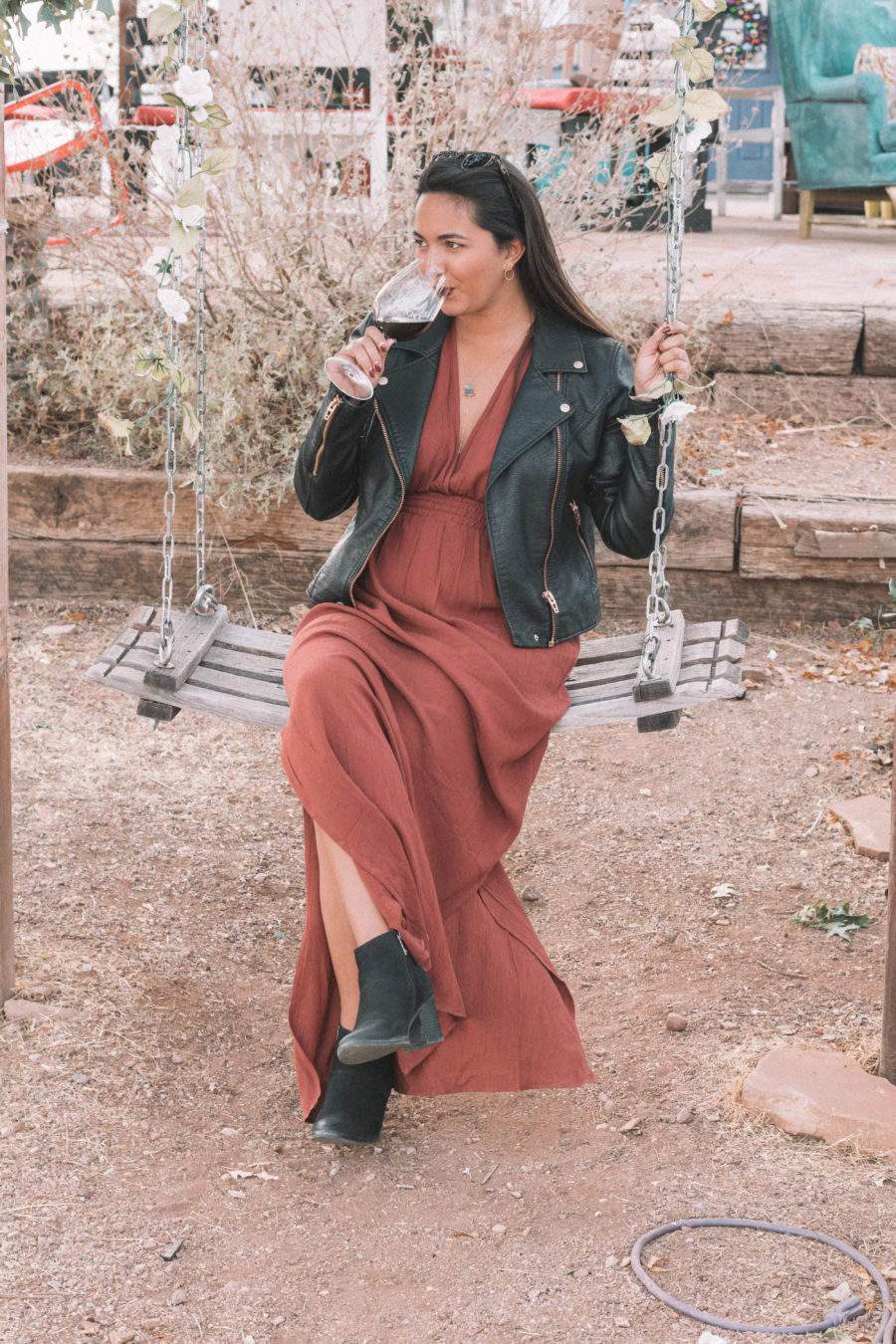 The perfect wine tasting outfit features a long dress and a moto jacket for some added edge!