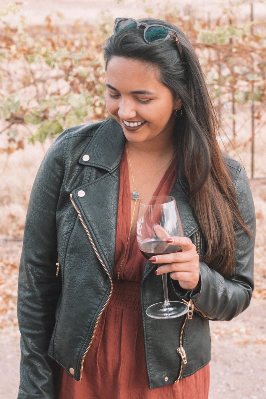 The perfect wine tasting outfit features a long dress and a moto jacket for some added edge!