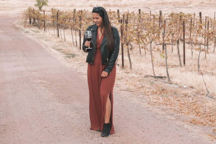 The perfect wine tasting outfit features a long dress and a moto jacket for some added edge!