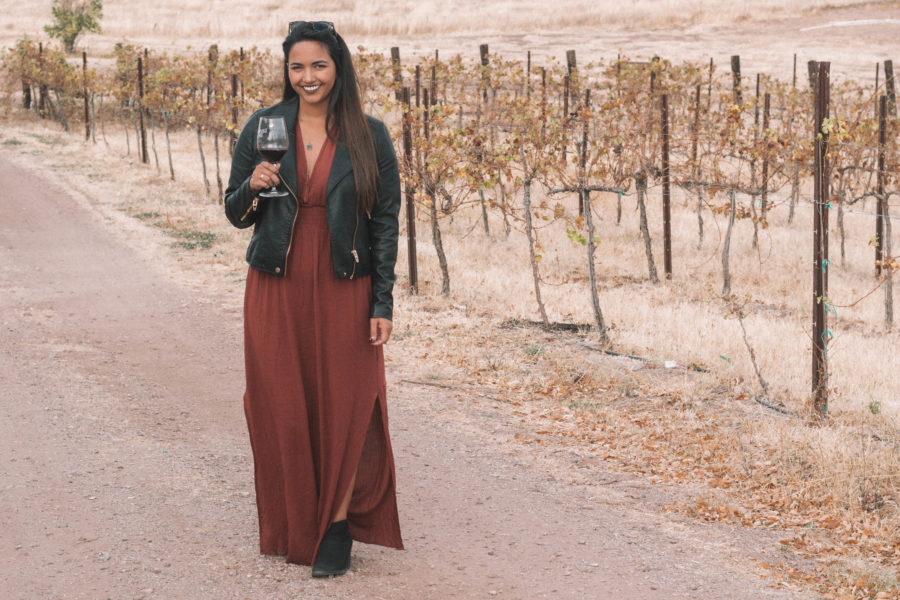 The perfect wine tasting outfit features a long dress and a moto jacket for some added edge!