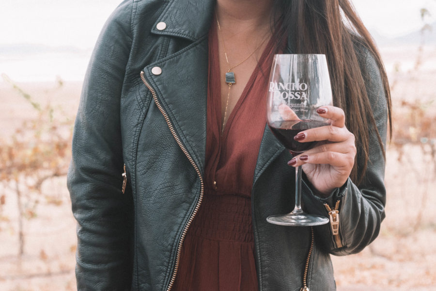 The perfect wine tasting outfit features a long dress and a moto jacket for some added edge!